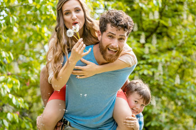 Portrait of smiling family against plants