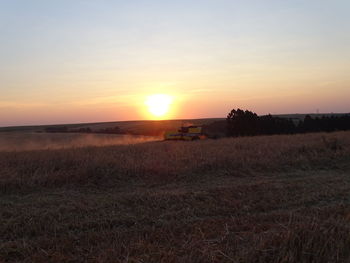 Scenic view of field against sky during sunset