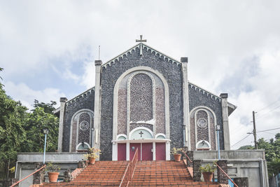 Steps and facade of christian church with stone walls. entrance to a chapel in roseau, dominica