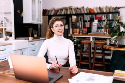 Portrait of woman working on table