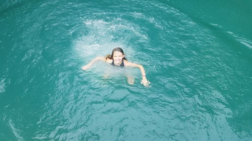 High angle view of woman swimming in sea