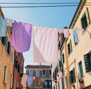 Low angle view of clothes drying on building against sky