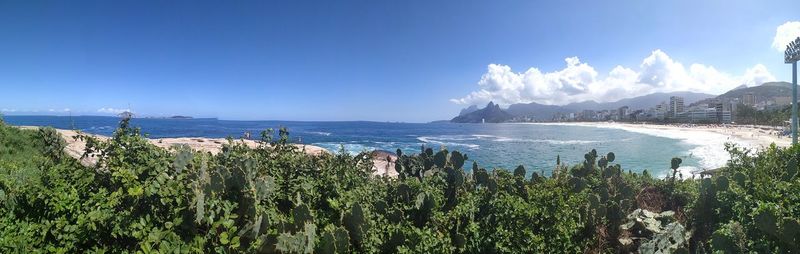 Panoramic view of sea against blue sky