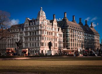 Buildings in city against blue sky