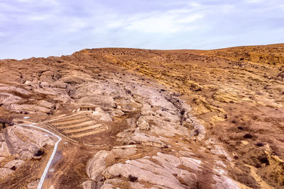 Scenic view of arid landscape against sky