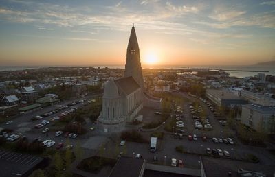 High angle view of buildings in city during sunset