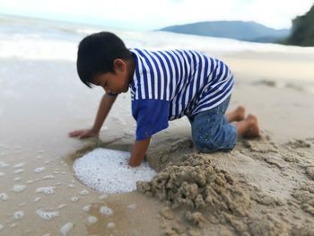 Boy playing on beach