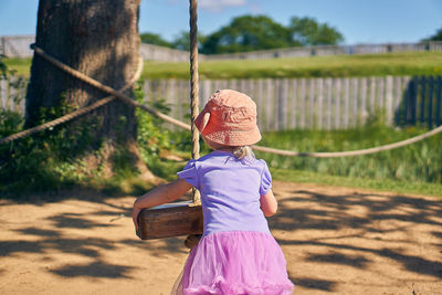 Rear view of girl wearing hat at playground