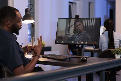 Midsection of man using laptop at office