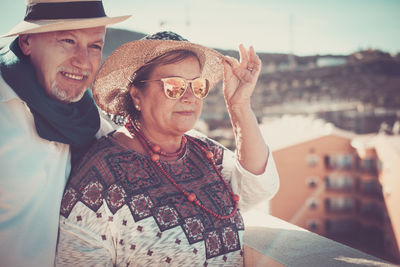 Senior couple wearing hats while looking away