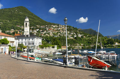 Boats moored in lake against landscape