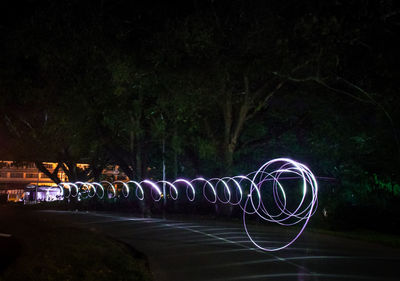 Light painting against trees at night