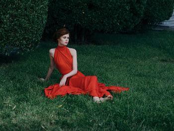 Young woman sitting on field