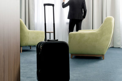 Midsection of businessman in hotel room