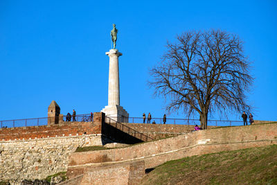 Low angle view of monument against clear blue sky