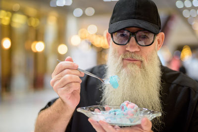 Portrait of man holding ice cream cone