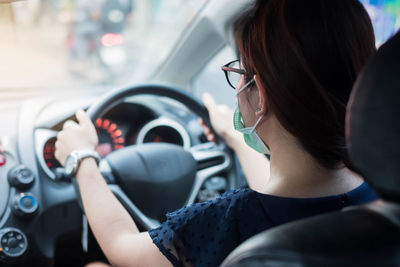 Rear view of woman in car