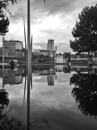 Reflection of buildings in lake against sky