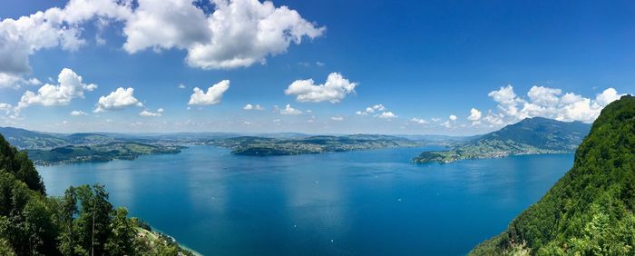 Panoramic view of lake and mountains against blue sky