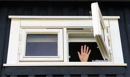 Man on window of building