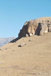 Rock formations in desert against clear blue sky