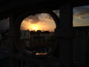 Silhouette cityscape against sky during sunset