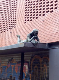 Low angle view of statue against building