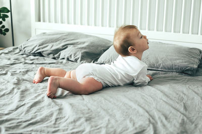 Boy lying on bed at home