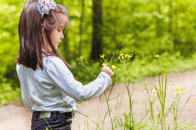 Side view of girl with plants