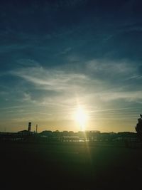 Scenic view of silhouette field against sky during sunset