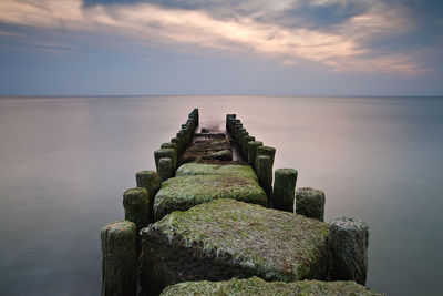 View of jetty at calm sea against the sky