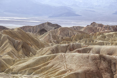 Scenic view of sea and mountains against sky