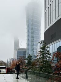 Rear view of man walking on street in city