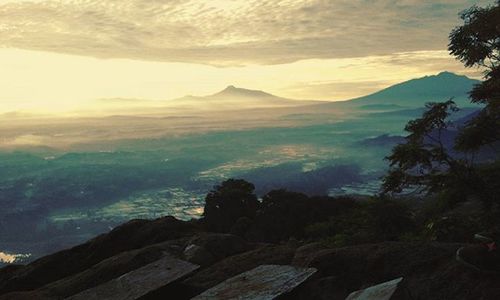 Scenic view of mountains against cloudy sky