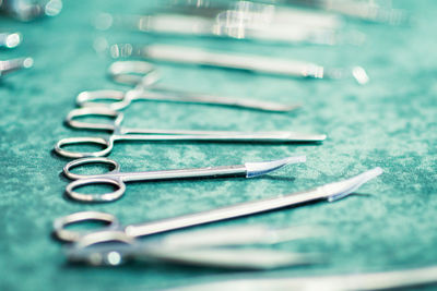 Close-up of metallic surgical scissors on table