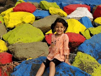 Portrait of smiling girl with multi colored umbrellas