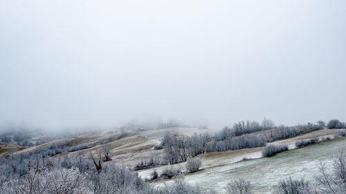 Snow covered land against sky