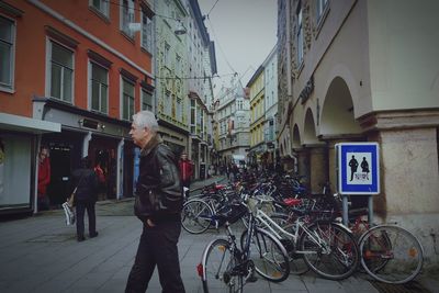 Bicycles on street amidst buildings in city