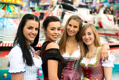 Portrait of happy women wearing dirndl at oktoberfest