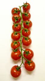 Close-up of tomatoes over white background