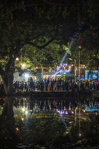 Group of people by the lake at night