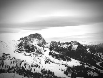 Scenic view of snowcapped mountains against sky during winter