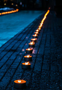 Close-up of illuminated oil lamp outdoors