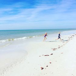 People on beach against sky