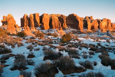 Scenic view of rock formation against sky during winter