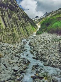 Scenic view of river against cloudy sky