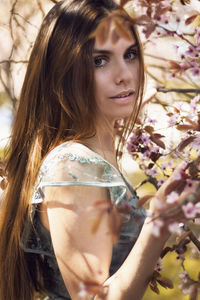 Portrait of beautiful woman with red flower