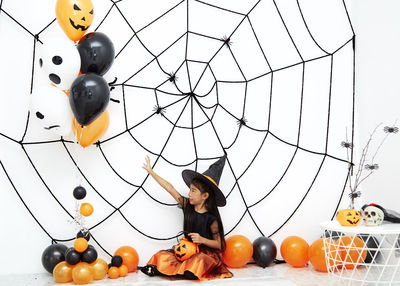 Low angle view of woman with balloon on balloons
