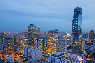 Illuminated cityscape against sky at night