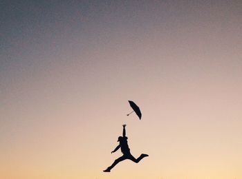 Low angle view of woman jumping in mid-air